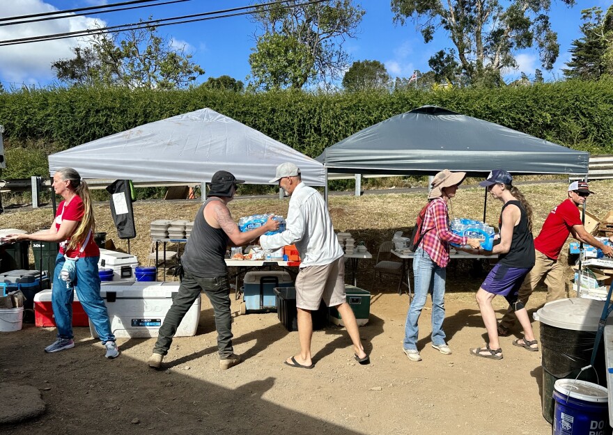For weeks after the 2023 wildfires, much of Kula's water was deemed unsafe for drinking due to contamination from the fire. Residents banded together to hand out essential supplies, seen here unloading bottled water in late August, 2023.