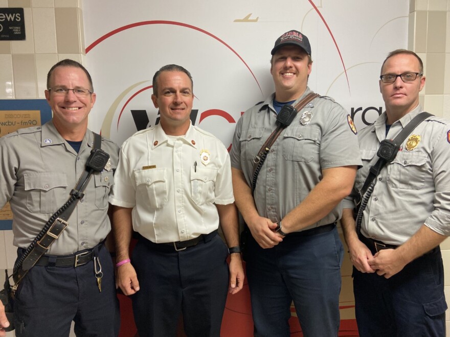 Fire engineer Brandon Schmitz (left), Chief Sean Sollberger, fire fighter Sam Kachanuk and Captain Derek Hammond in the WCBU studio to talk about the transition to the new Edward B. Gaines, Jr. Fire Station 4.