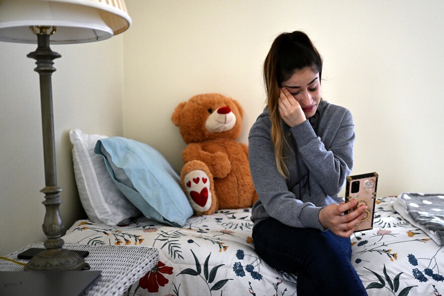 Nilab Hanifi, 19, on Afghan New Year's Day in Bridgeport, Connecticut, March 20, 2022. Nilab called her mother, Mariza Hanifi, and her father, Mohammd Aziz Hanifi, in Afghanistan, wiping tears the whole time to wish them a quick happy new year during the short time on the phone. Then it was a shopping trip to a halal food store followed by Afghan tea with Concetta “Lina” Rinaldi, her husband, Mario Rinaldi, their son Alex Rinaldi, 42, and new friend Safia Rezwani, 23, before going shopping again at Goodwill in Bridgeport.