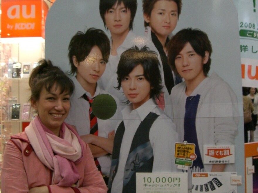 Marie Mutsuki Mockett is the author of <em>Picking Bones from Ash.</em> She is pictured here with a poster of the Japanese boy band, Arashi, in Kyoto, Japan. Band member Jun Matsumoto (center) played Doumyoji in the televised version of <em>Hana Yori Dango</em>.