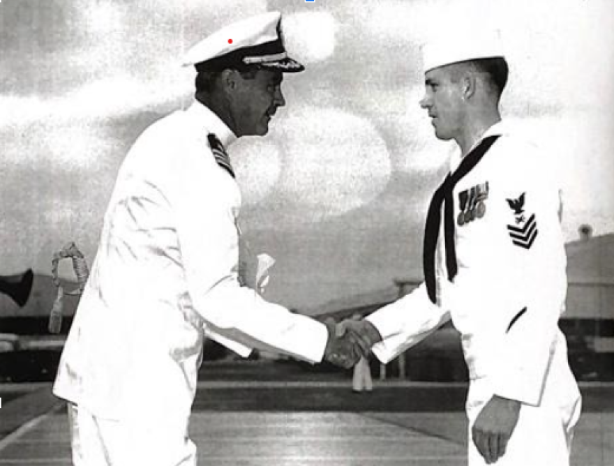 Petty Officer First Class Bill Curtis shakes Captain Ryan’s hand during a ceremonial event on September 8, 1961, at NAS North Island in San Diego, California.