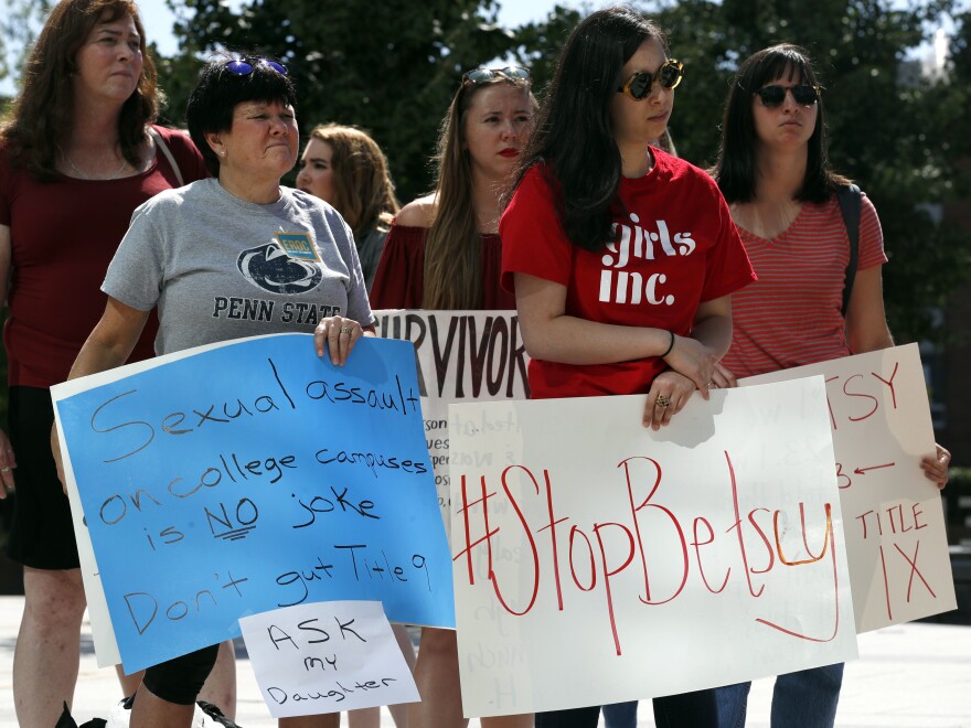 Sonja Breda, 23, (right) sends a message to Education Secretary Betsy DeVos with a "Stop Betsy" sign as survivors of sexual violence and their supporters protest before DeVos spoke in September 2017 at the George Mason University's Arlington, Va., campus.