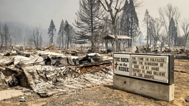 A church marquee stands among buildings destroyed by the Dixie Fire in Greenville on Thursday, Aug. 5, 2021, in Plumas County, Calif.