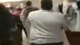 A screenshot from a cell phone video taken at Wake Forest High School shows an altercation between a black and a white student.