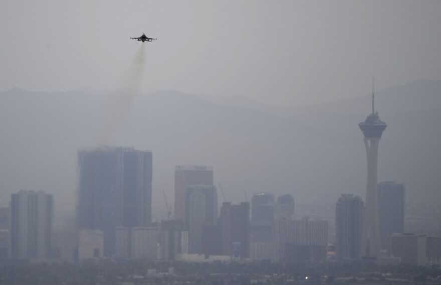 A fighter jet takes off from Nellis Air Force Base as a haze blankets the Las Vegas valley, Tuesday, July 31, 2018, in Las Vegas. Dense smoke from a series of wildfires burning in California has triggered air quality alerts across more than a 400-mile stretch of Nevada from Reno to Las Vegas. (AP Photo/John Locher)