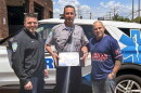 An undated photo shows Scott Montellaro, a paramedic field training officer at American Medical Response New Haven's offices. as he received an award for 30 years of service. Montellaro is in the middle, flanked from right to left by Dave Laspino, an AMR Paramedic Supervisor and Clinical Education Supervisor, and Michael Turcio an AMR Operations Manager, New Haven.
