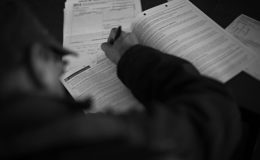 Isaac Oxereok, 69, fills out the papers needed to register for full VA care and benefits. Oxereok was in the Army and served in Vietnam from 1966-67.