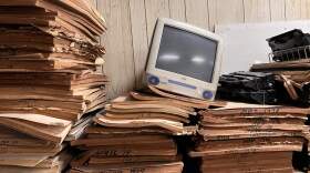  A discarded iMac rests on top of bound copies of The Welch News. (Todd Melby)