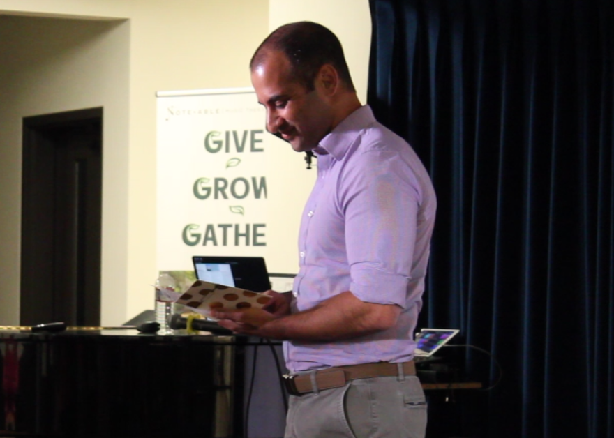 Dr. Feroze Sidhwa reads a card written by local Palestinian artist.
