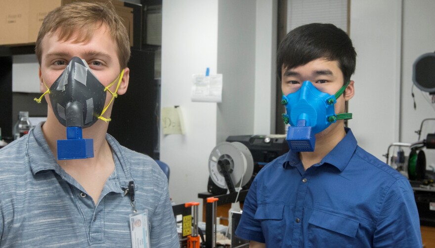 John Yost and Joshua Kim model first and second prototypes of 3D printed masks created by a team at the Medical University of South Carolina.