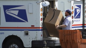An Amazon package is loaded onto a U.S. Postal Service truck, Tuesday, Aug. 18, 2020, Portland, Maine.