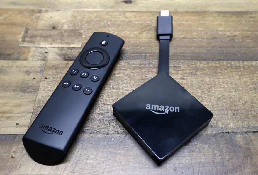 An Amazon Fire TV streaming device with its remote control. On Tuesday, Dec. 5, 2017, Google announced plans to pull its popular YouTube video service from Amazon's Fire TV and Echo Show devices in an escalating feud that has caught consumers in the crossfire. (Elaine Thompson/AP)