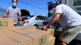 People load their vehicles with boxes of food at a Los Angeles Regional Food Bank earlier this month in Los Angeles. Food banks across the United States are seeing numbers and people they have never seen before amid unprecedented unemployment from the COVID-19 outbreak.