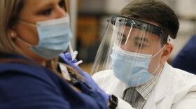 Ohio State employee Cory Coffey, right, administers a Pfizer-BioNTech COVID-19 vaccine Monday, Dec. 14, 2020, in Columbus, Ohio.  (Jay LaPrete/AP)