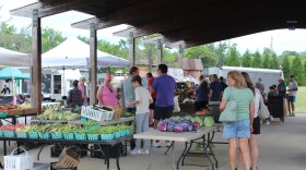 Patrons browse tables of fresh produce at the Waynesboro Farmers Market.