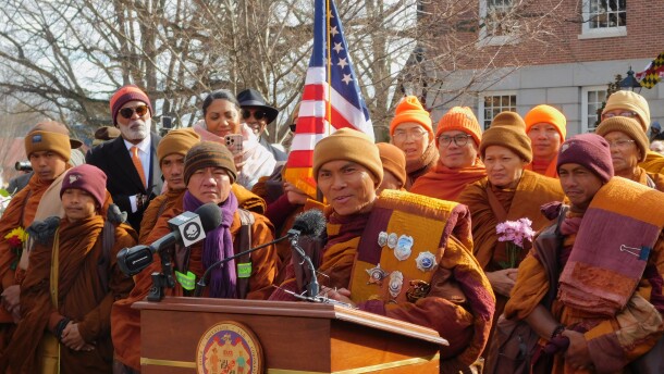 Theravada Buddhist monk Venerable Bhikkhu Paññākāra promotes his message of peace to thousands of spectators on Thursday outside the Maryland State House in Annapolis, Md.