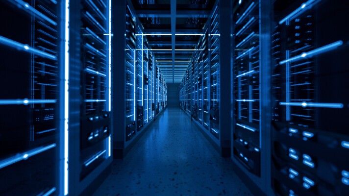 An artistic photo showing a row full of data servers with soft blue light
