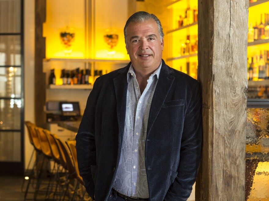 a man leans against a wall