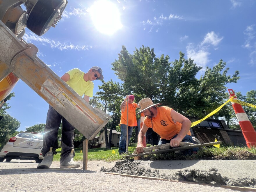 A crew from Quality Custom Construction pours a curb at the corner of NW Hackberry Lane and Lake Drive in Lee’s Summit early Monday afternoon. At midmorning, the temperature in Lee’s Summit was already 89 degrees.