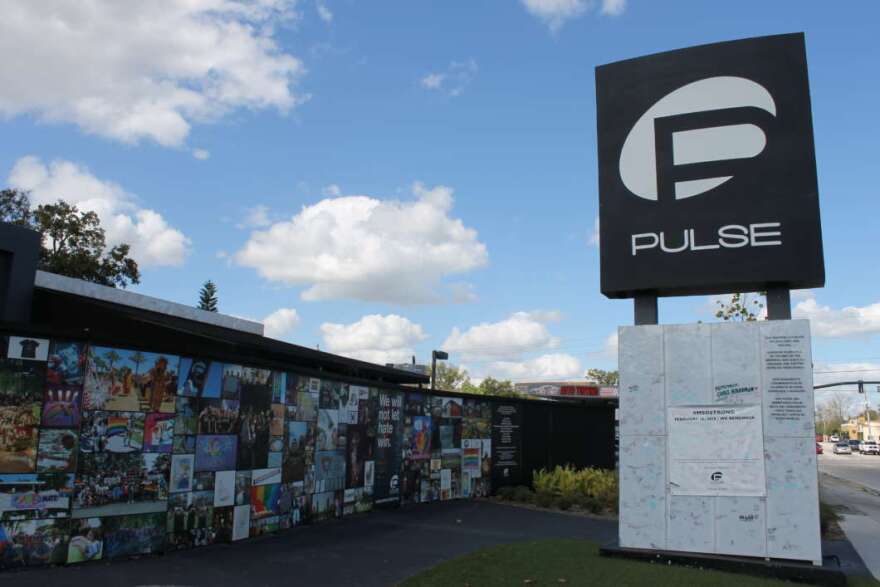 Visitors to the Pulse memorial are invited to write messages of love and support on a banner destined for Parkland. Photo: Matthew Peddie / WMFE