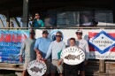 Group of men stand with their plaques that denote them as having caught the largest fish in the tournament for the youth division and overall