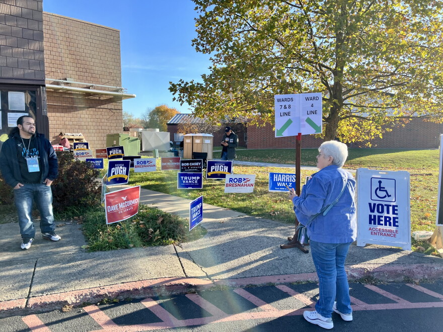A voter prepares to enter the Kingston Recreation Center polling place in Luzerne County Tuesday morning amid a welter of campaign signs and volunteers for the various candidates.