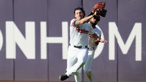Cleveland Guardians center fielder Chase DeLauter (34) catches a fly ball hit by Detroit Tigers' Riley Greene (31) while avoiding a collision with right fielder George Valera (35) during the sixth inning of Game 3 of the American League Wild Card baseball playoff series in Cleveland, Thursday, Oct. 2, 2025. 