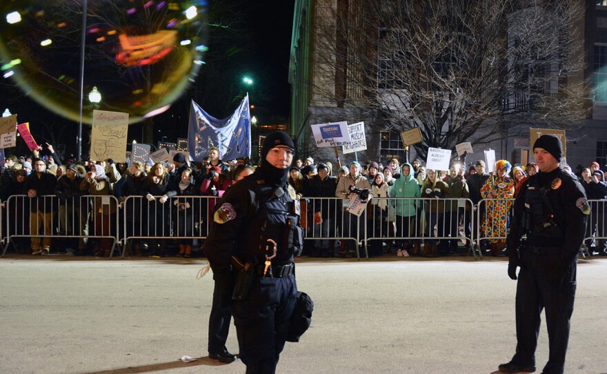 Police monitor protesters outside Thursday's Donald Trump campaign event in Burlington, Vt.