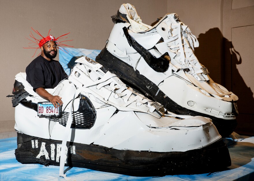 Aaron Fowler poses alongside his sculpture “Live Culture Force 1’s, 2022” on Friday, Aug. 25, 2023, at the St. Louis Art Museum. Fowler’s work will be on display at the museum through the end of the year, as part of “The Culture: Hip Hop and Contemporary Art in the 21st Century” exhibit.