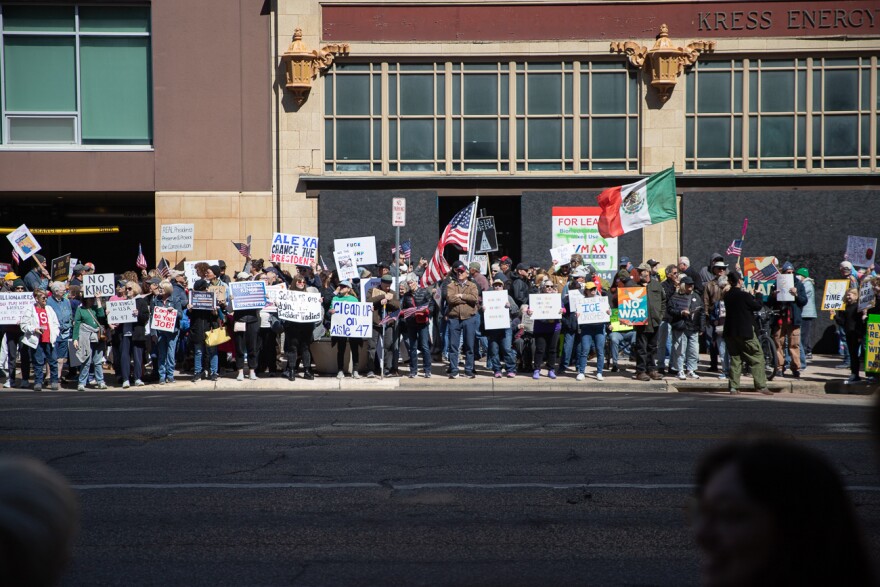 Demonstrators stand along Douglas Avenue during the No Kings protest on Saturday, March 28, 2026.