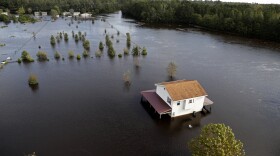 A house is surrounded by floodwaters from Hurricane Florence in Lumberton, N.C., Monday, Sept. 17, 2018.