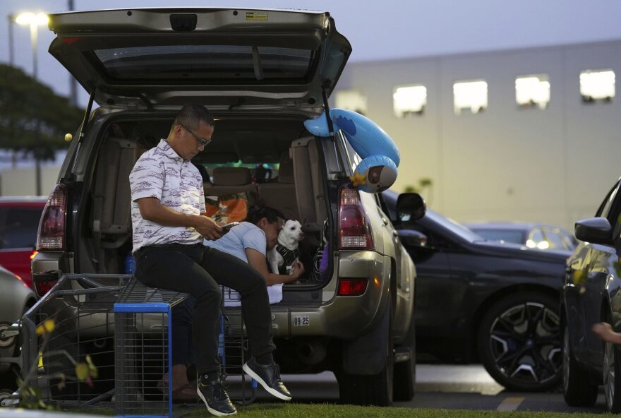 Oahu residents seek refuge from the threat of a tsunami in a Walmart parking lot in Kapolei, Oʻahu, Hawaiʻi, Tuesday, July 29, 2025. (AP photo/Michelle Bir)