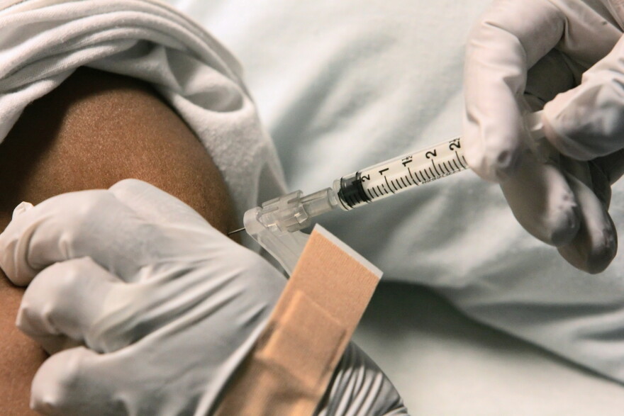 A sickle cell disease patient is given an injection for pain relief by a nurse