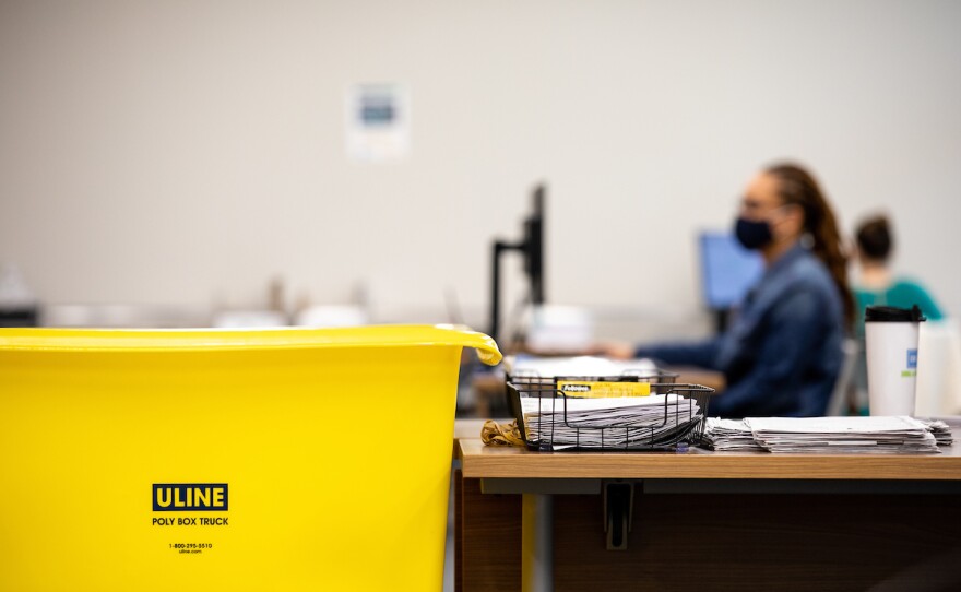 Workers at the Durham County Board of Elections process absentee ballot requests while maintaining safety during the coronavirus pandemic in Durham, N.C. on Tuesday, Aug. 18, 2020. 