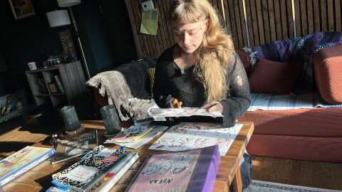 Eleanorah-Pearl Antons working on zines, mini-magazines, at her Norfolk home. The hand-crafted books have resurged in popularity, artists say, as people want to disconnect from social media and AI-generated content.