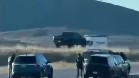 A bystander's video shows what appear to be federal agents around a car parked on the eastbound on-ramp at U.S. Highway 40 exit 4 early April 29, 2026.