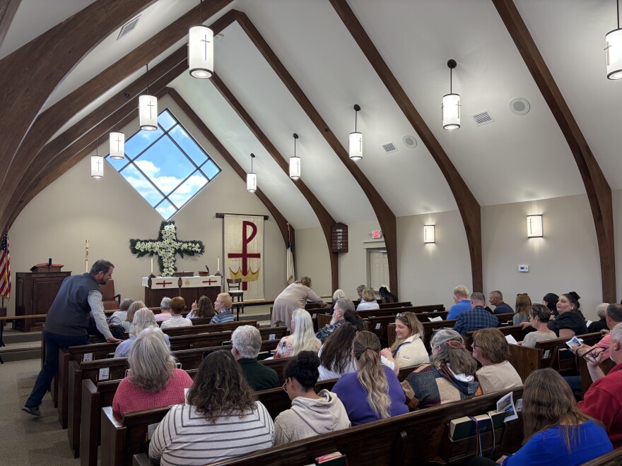 Members of the Redeemer Lutheran Church gather in the sanctuary to mark the dedication of the rebuilt church on Thursday, May 7, 2026.