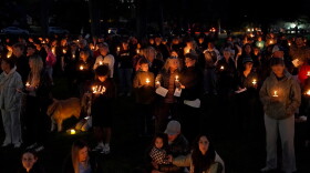 People gather for a candlelight vigil held in Drake Park in Bend, Ore., Oct. 15, 2026, following the shooting at Silver Rail Elementary School earlier in the day.