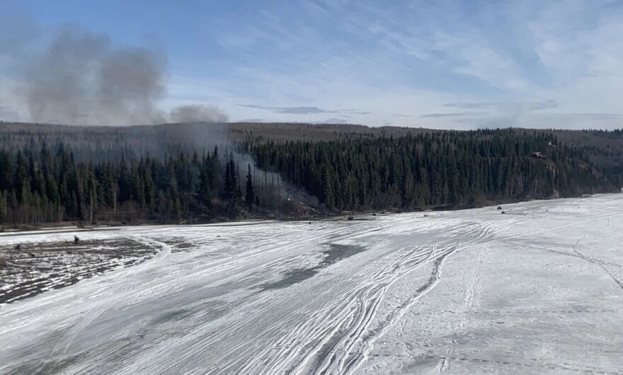 Smoke rises from the site of Tuesday morning's plane crash along the Tanana River west of Fairbanks