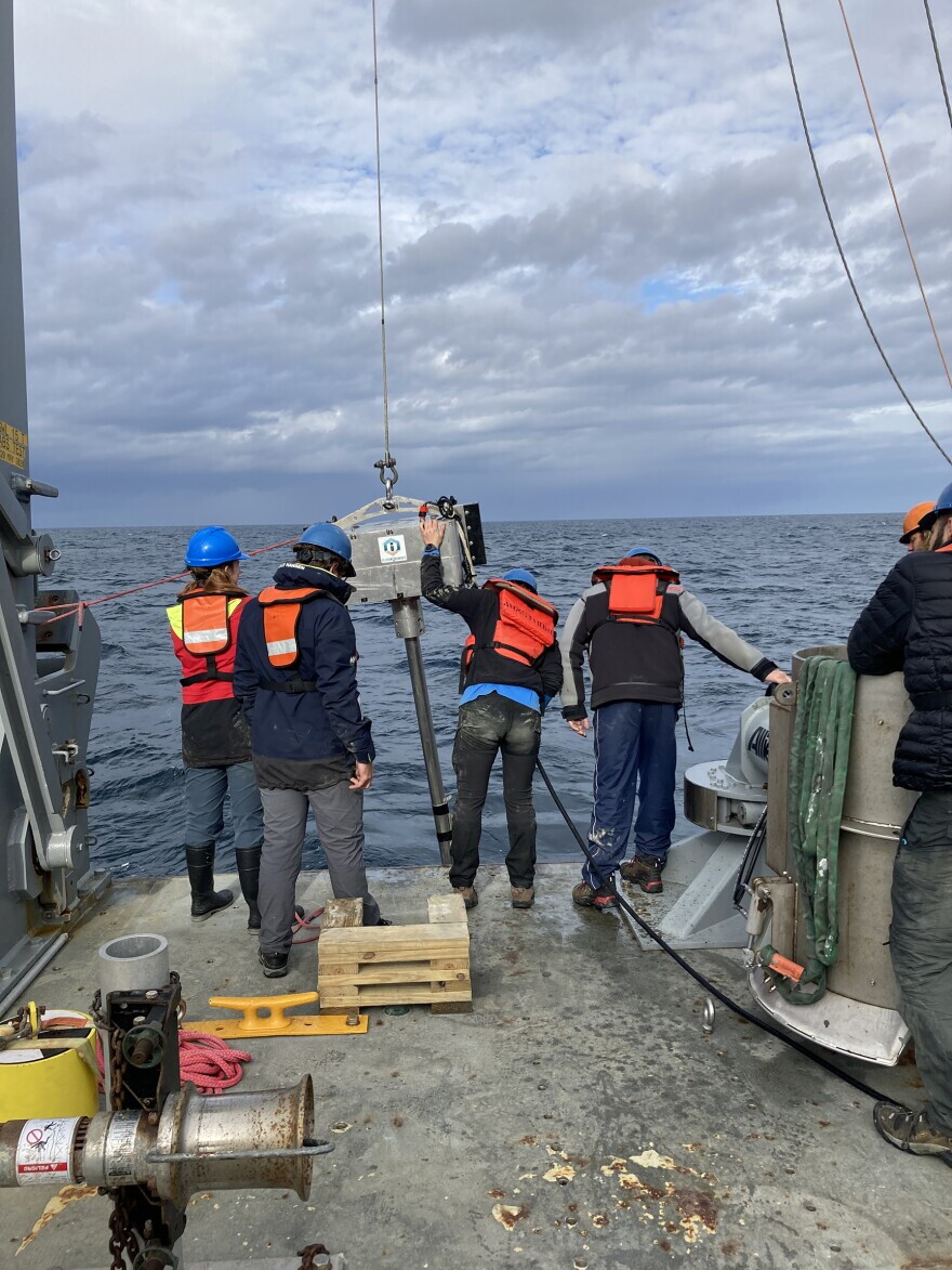 Researchers on the vessel Armstrong use a vibracore tool to gather sea floor sediments.