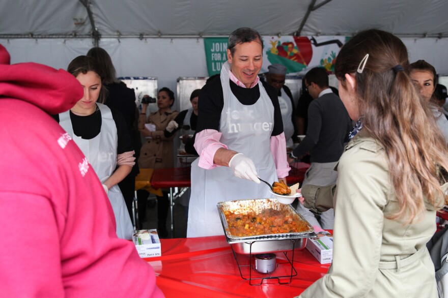 Volunteers serve curry at the Feeding the 5000 event.