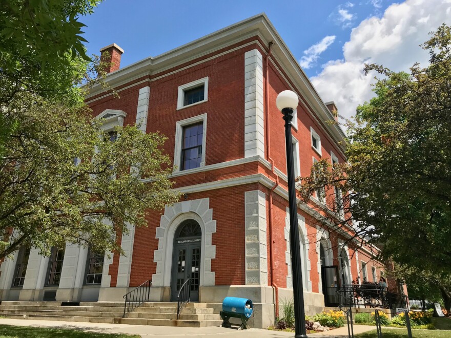 A three story red brick building.