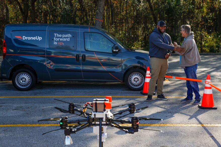 Matthew Credle, 30, left, who is a DroneUp hub leader, and Buz Massengale, 73, right, who is a retired FAA safety inspector, share a moment after a discussion at a Walmart Spuercenter in Tampa on Tuesday, January 24, 2022.
