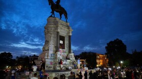 People gather around the Robert E. Lee statue on Monument Avenue in Richmond, Va., on June 4. Thursday a judge issued an indefinite injunction preventing the state from removing the statue.