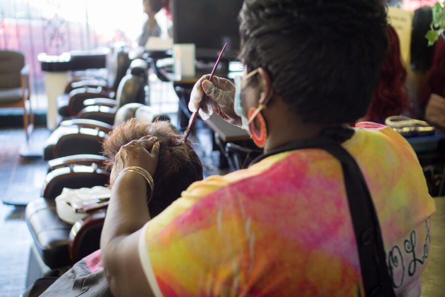 Montella Wimbley, owner of Profiles Beauty Salon in Wichita, gives Robin Loggins her first cut and color in eight weeks.