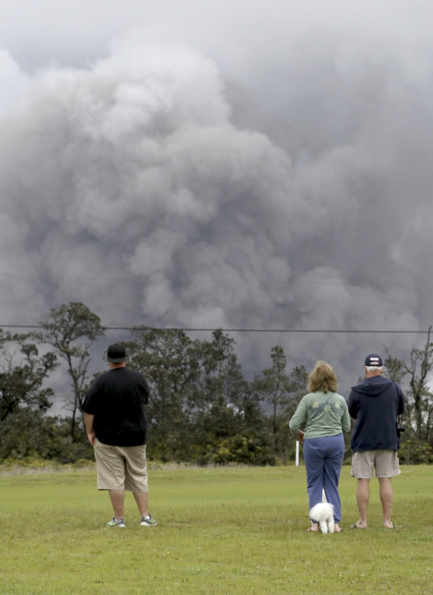 People watch as ash rises from the summit crater of Hawaii's Kilauea volcano on Thursday.