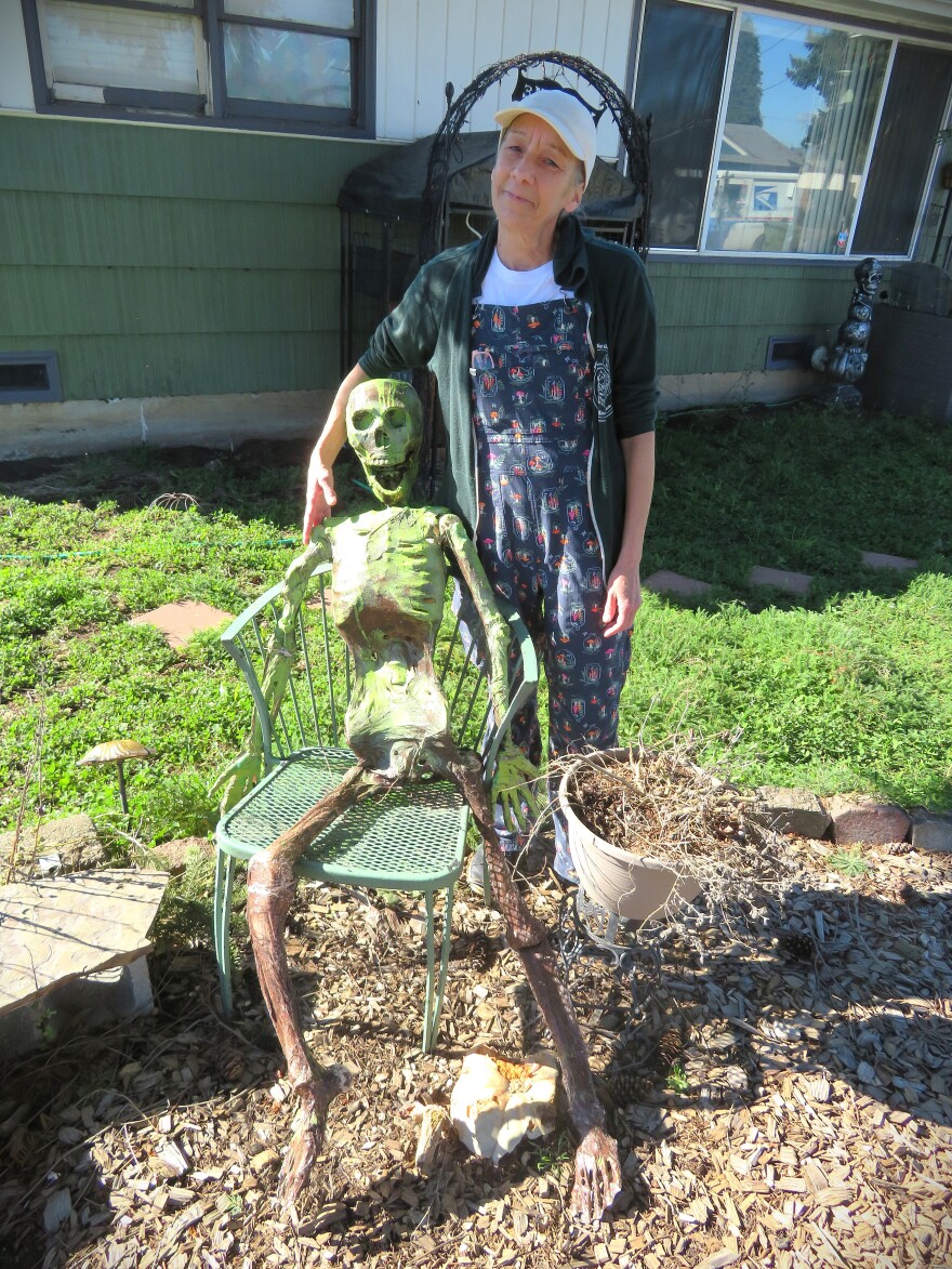 Woman with plastic skeleton decoration.