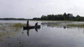 Two fisherman in a boat, fishing on a small Itasca County lake.