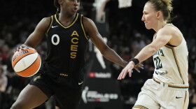 Las Vegas Aces guard Jackie Young (0) drives against New York Liberty guard Courtney Vandersloot (22) during the second half in Game 1 of a WNBA basketball final playoff series Sunday, Oct. 8, 2023, in Las Vegas.