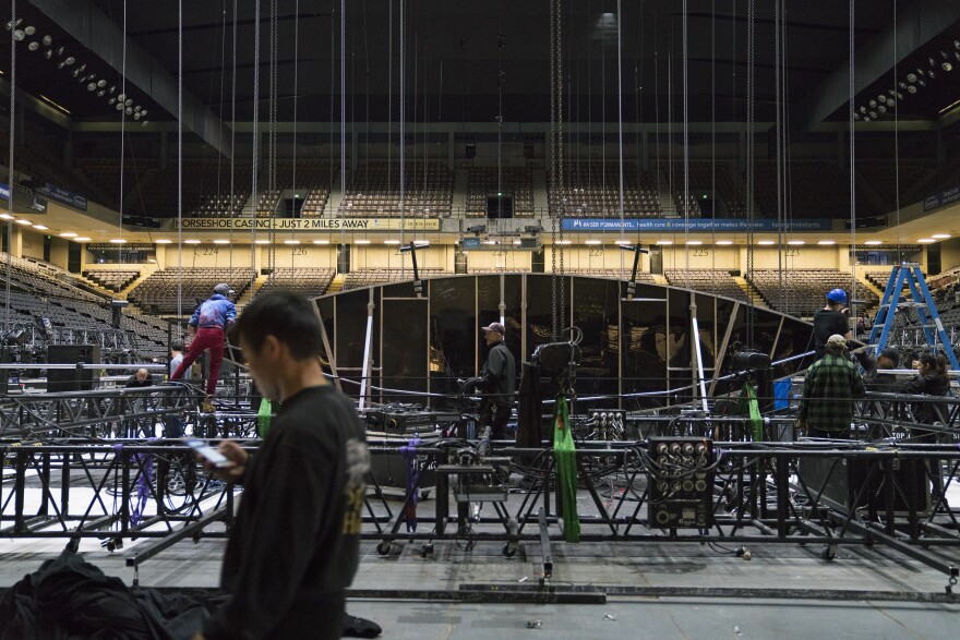 Members of the crew work on the grid, a massive aluminum structure that will eventually be hoisted 40 feet into the air.